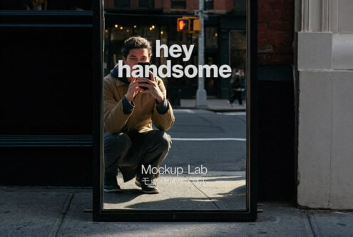 Street window poster showing guy holding phone with hey handsome text overlay