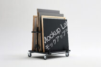 Wheeled frame stand displaying wooden frames with dark chalkboard mockup insert