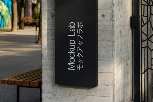 Dark signage with vertical Mockup Lab text on urban wall