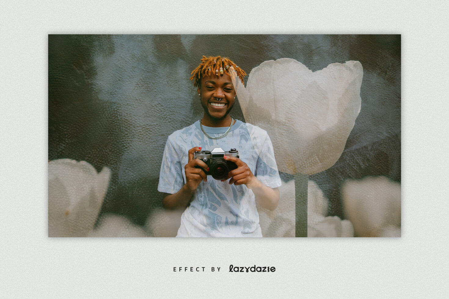 Person with orange hair holding vintage camera surrounded by white flowers
