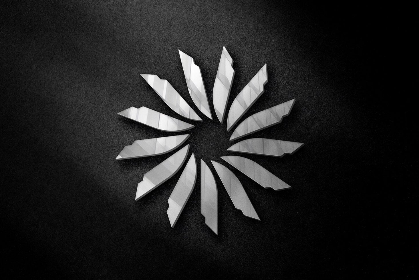 Circular starburst pattern with pointed metallic blades radiating from center