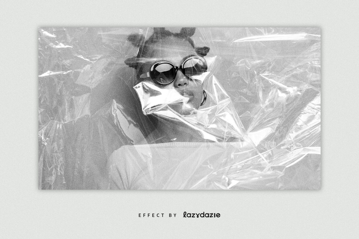 Grayscale portrait with round sunglasses wrapped in crinkled cellophane texture