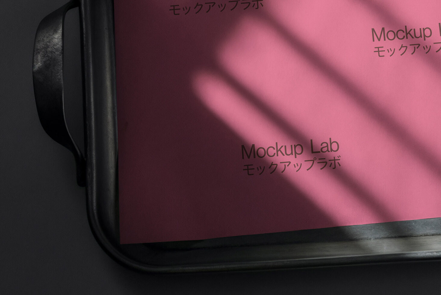Pink laptop screen with Mockup Lab branding in sunlight