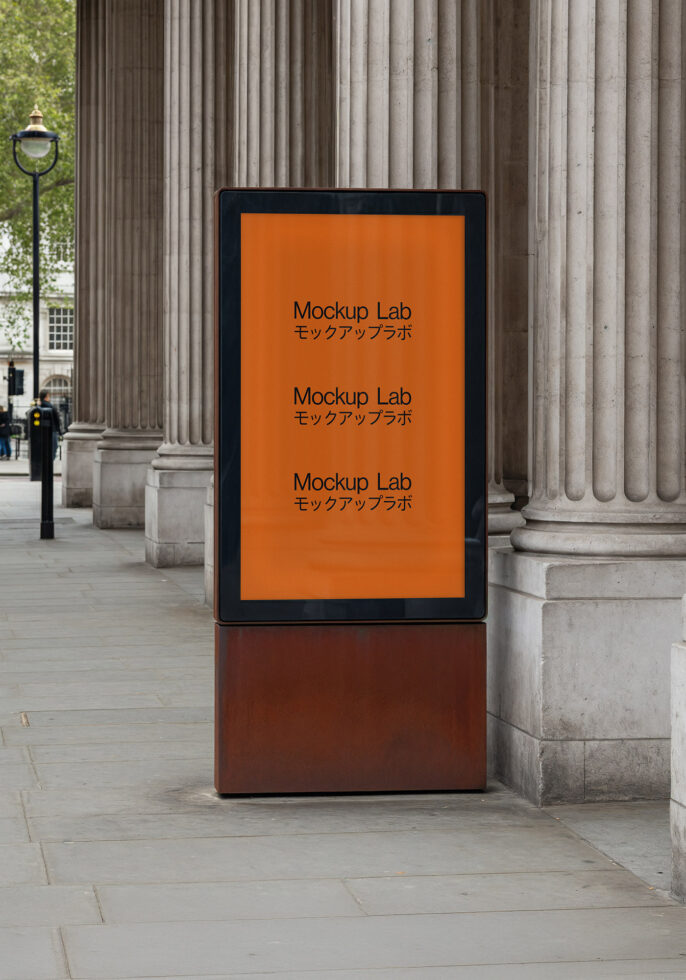 Street-level digital sign displaying orange mockup layout by classical architecture