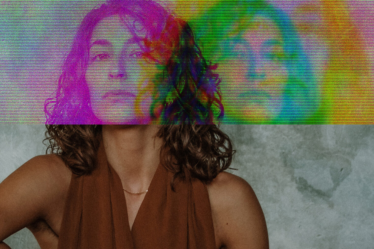 Woman in brown top with colorful glitch stripes covering her head