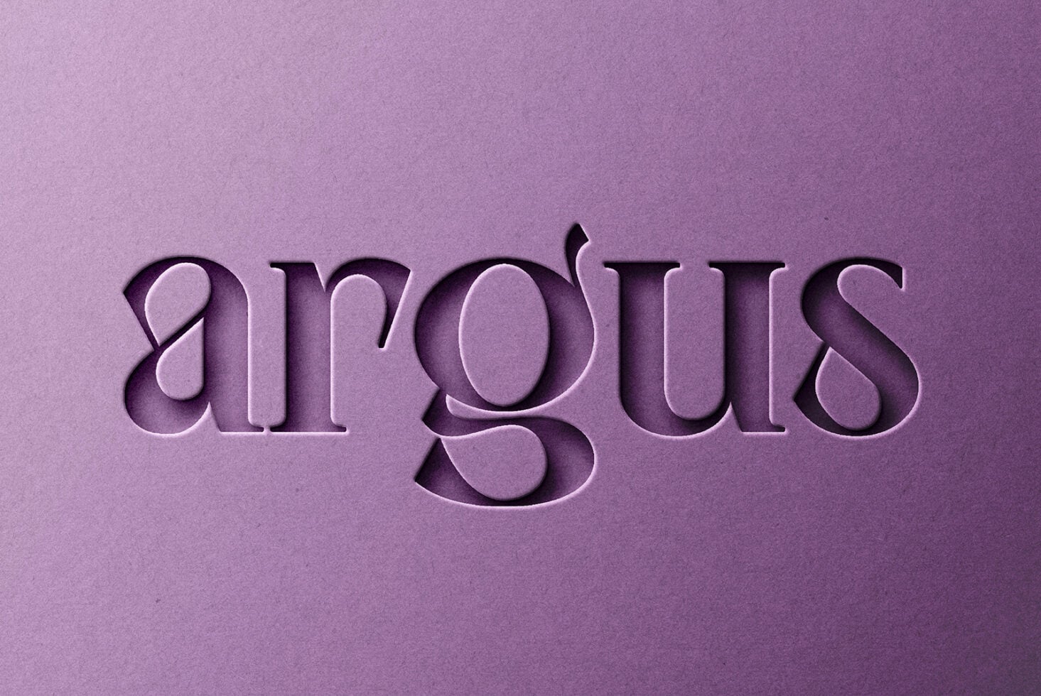 Pressed serif text reading airgoths on mauve paper with engraved effect