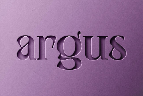 Pressed serif text reading airgoths on mauve paper with engraved effect