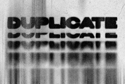 Grunge text effect displaying word Duplicate with distorted layers and texture. Ideal for use in graphics, typography, and design mockups for digital assets.