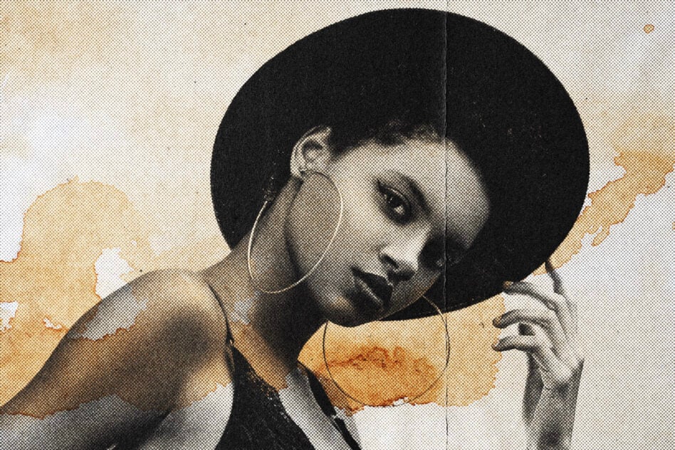 Aged monochrome photo with large black afro, distressed paper texture overlay