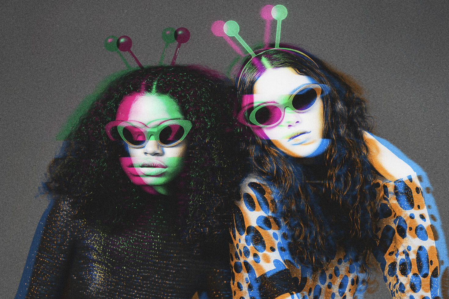Two figures in alien costumes wearing heart-shaped sunglasses, chromatic glitch