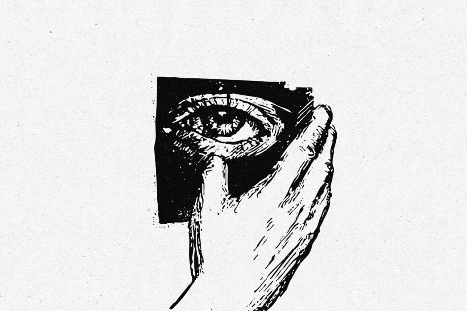 Hand holding detailed sketch of eye on black square against light background