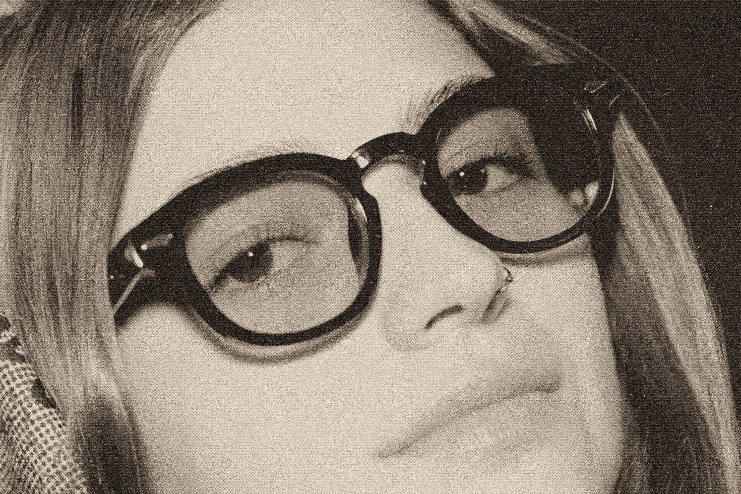 Grainy close-up of two women wearing oversized round sunglasses with retro vibe