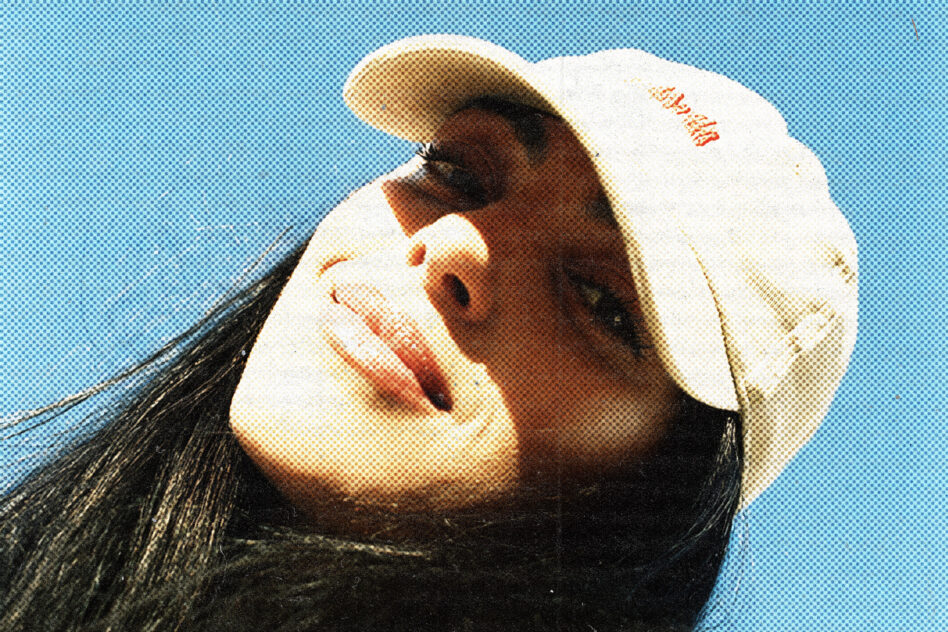 Profile portrait wearing white cap with halftone pattern on blue backdrop