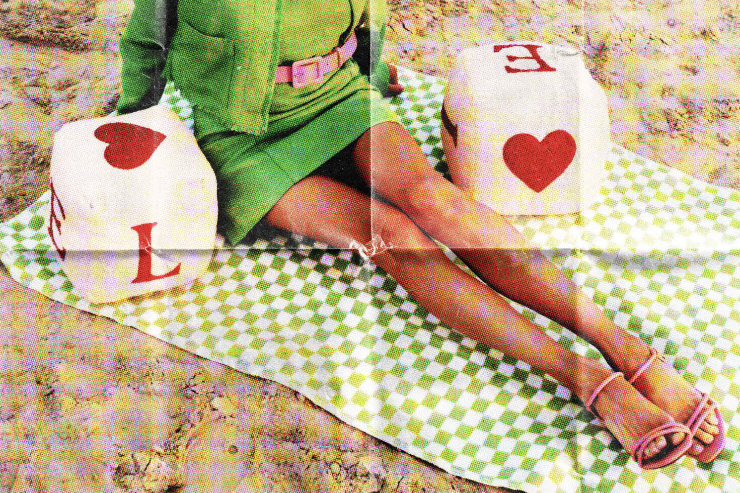 Printed fabric swatches with red hearts on sand background, colorful summer aesthetic