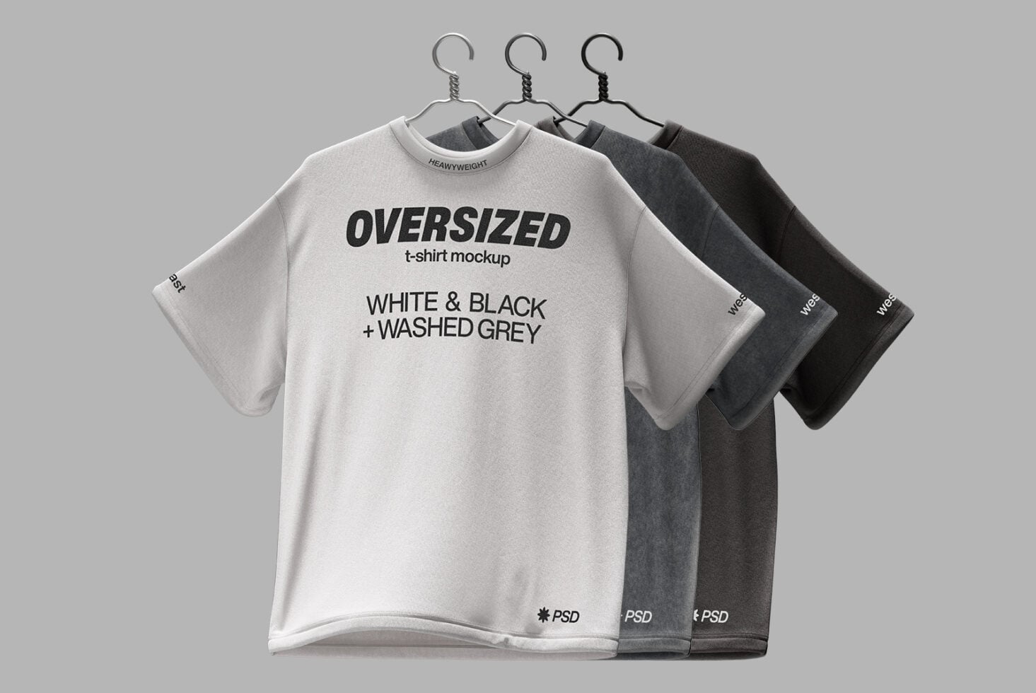 Three oversized tees in cream gray black on hangers front view