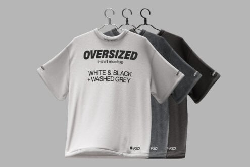 Three oversized tees in cream gray black on hangers front view