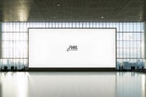 Massive blank gallery wall with tiny centered logo, minimalist museum setting