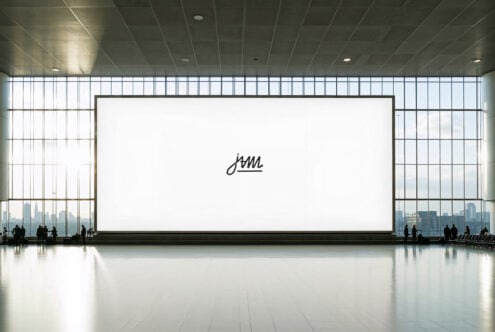 Large empty indoor space with giant window and blank billboard mockup; perfect for showcasing branding and advertisement designs. Ideal for designers.