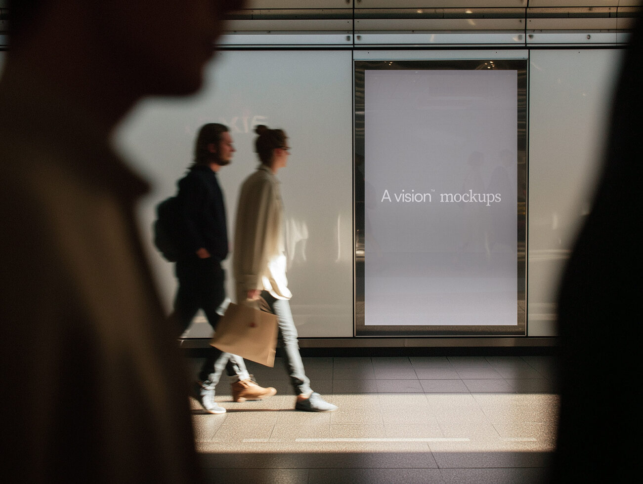 Empty transit poster mockup on bright corridor wall with moving pedestrians