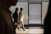 Blank screen display on mall window with two people walking by