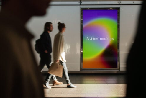 Colorful gradient display on mall window with two people walking past