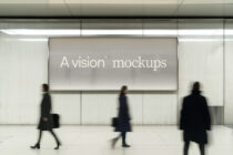 Large horizontal billboard with minimal gray display in transit station, blurred commuters walking by