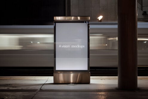 Vertical street kiosk with blank light gray display mounted on steel frame at night
