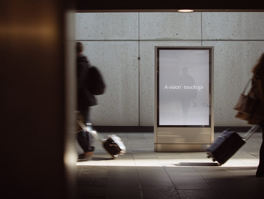 Empty screen on subway kiosk with blurred people walking past