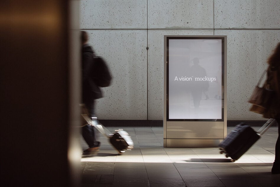 Blank screen on concrete subway kiosk at night