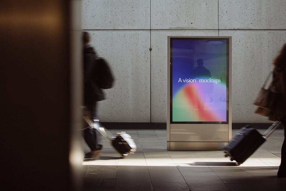 Colorful gradient display on concrete subway kiosk at night