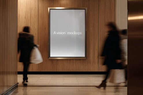 Framed portrait display on wood wall with people walking past in blurred motion
