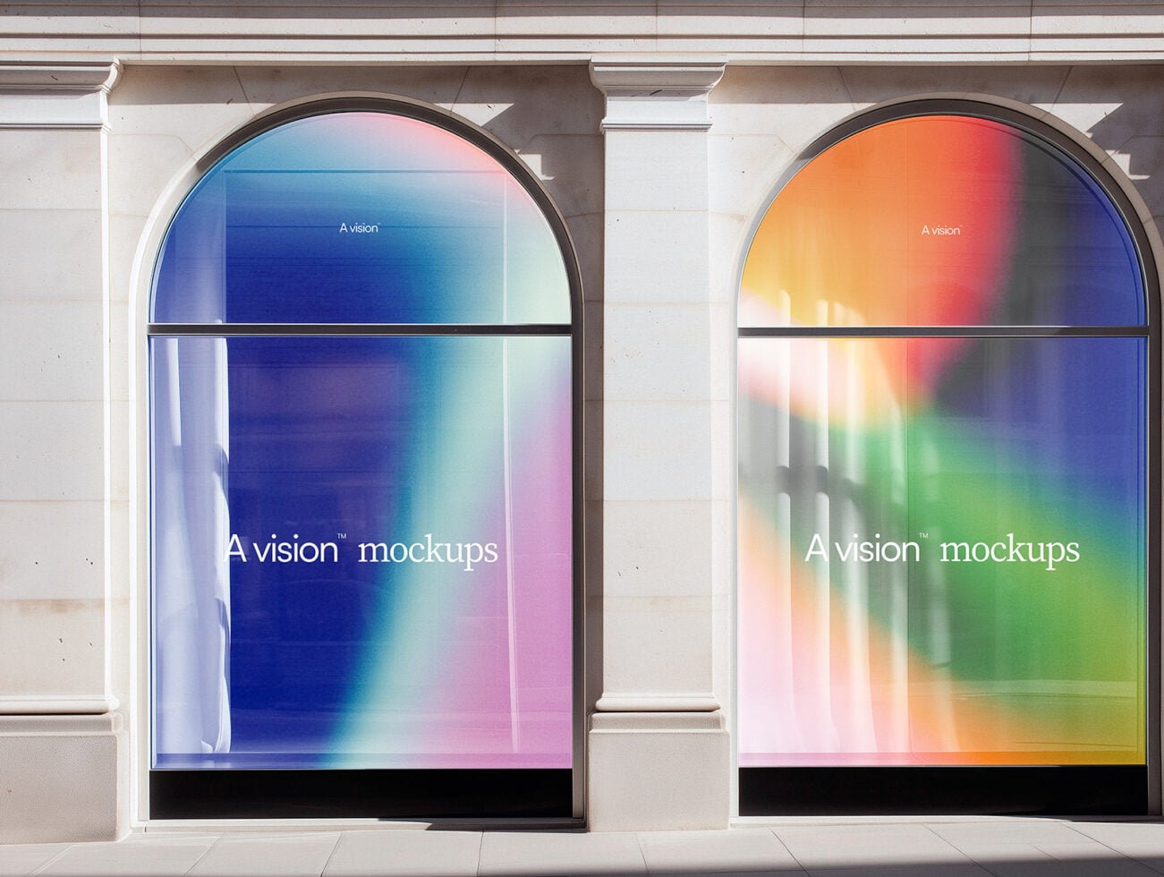 Pair of arched storefront windows with vibrant gradient displays in blue, pink, orange