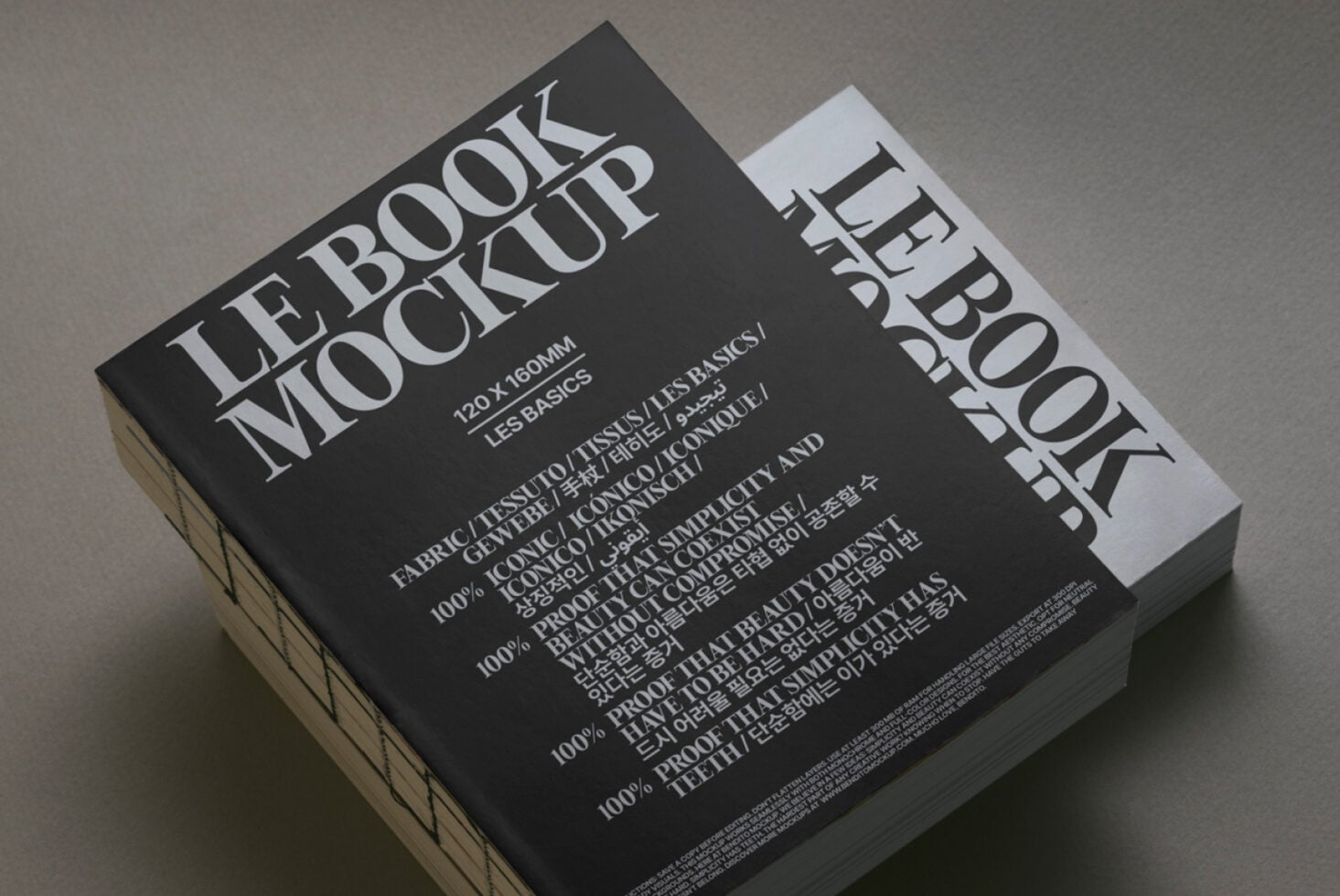 Black book mockup with white spine angled view on neutral surface