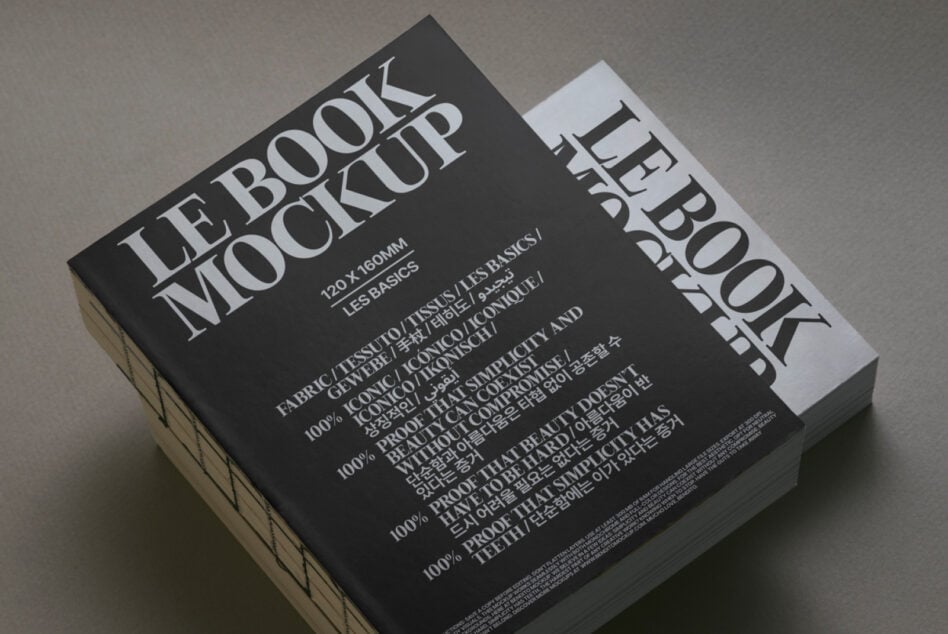 Black book mockup with white spine angled view on neutral surface