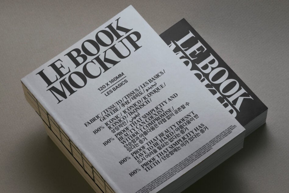 White book mockup with black spine angled view on neutral surface