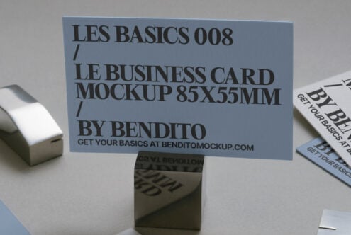 Blue business card mockup 85x55mm standing on holder with printed samples nearby