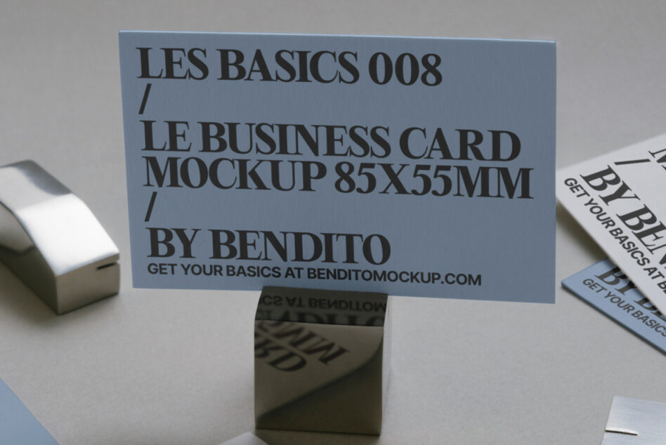 Blue business card mockup 85x55mm standing on holder with printed samples nearby