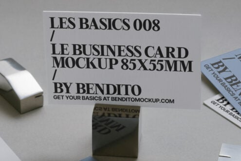Business card mockup 85x55mm on display stand with scattered printed card variations