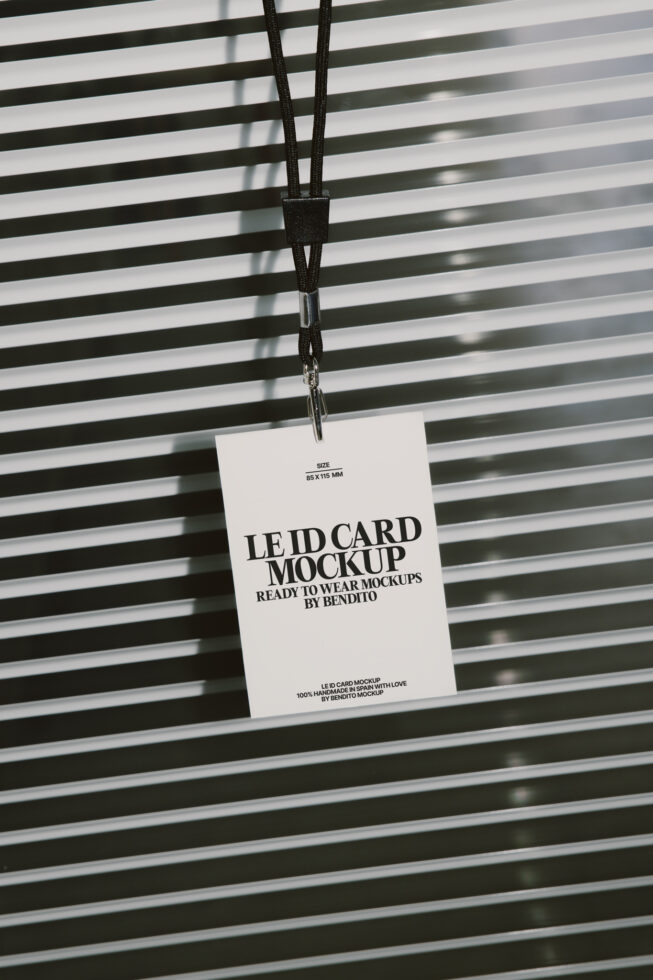 White lanyard ID card hanging against striped background with shadow play