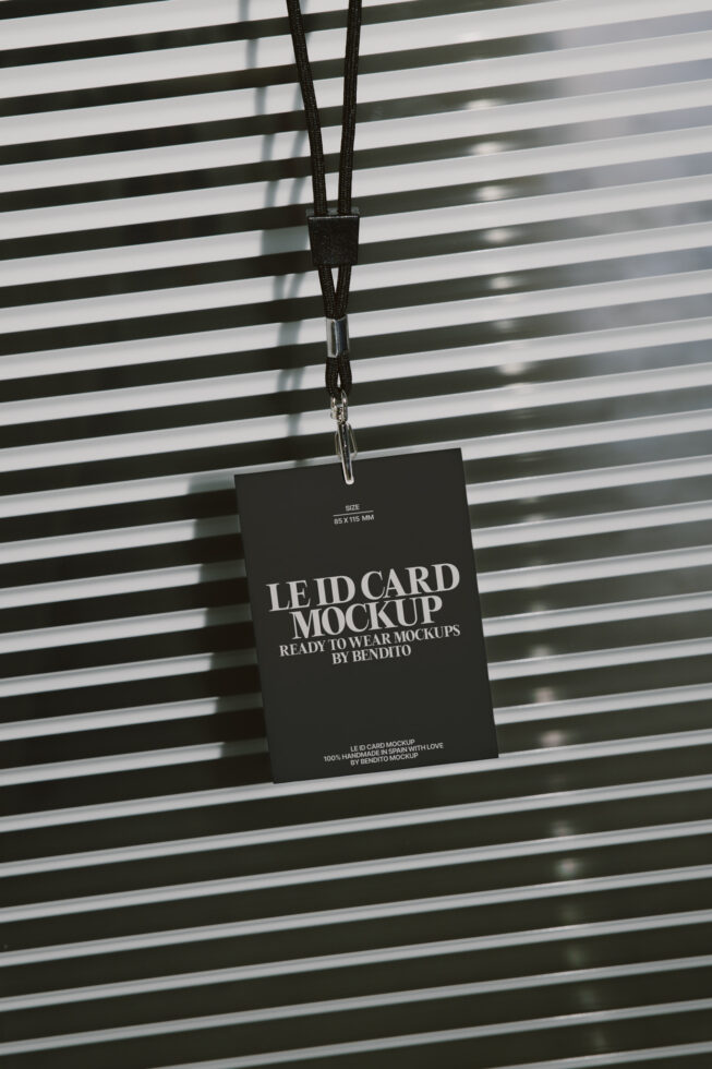 Black lanyard ID card hanging against striped background with shadow play