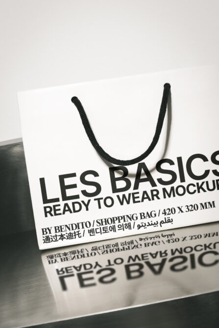 White shopping bag mockup with black rope handles displayed at angle