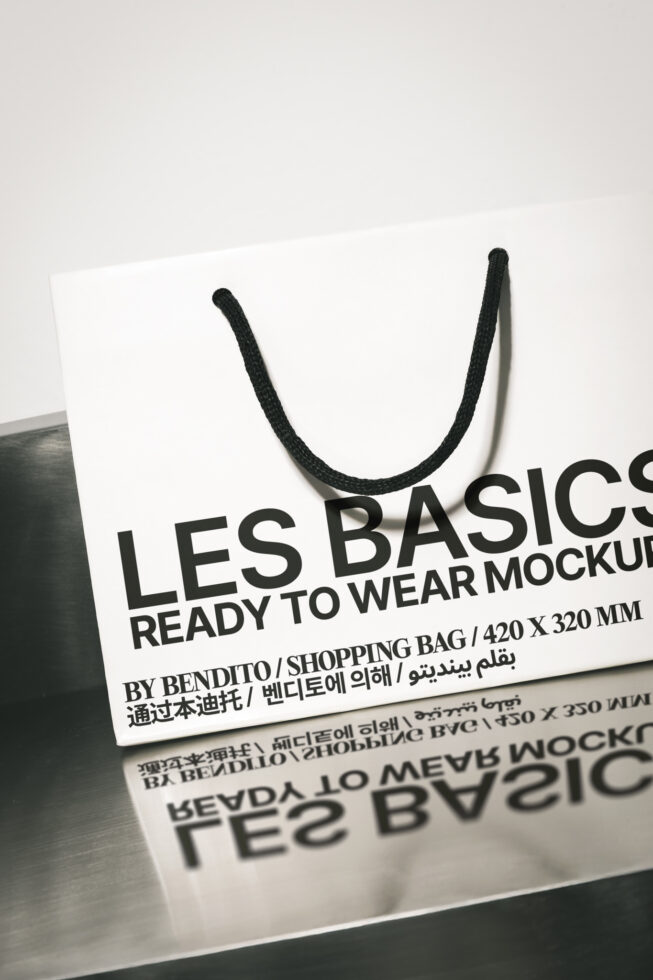 White shopping bag mockup with black rope handles displayed at angle