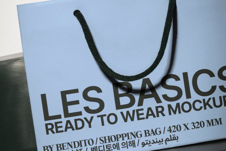 Blue shopping bag mockup with rope handles showing front branding text