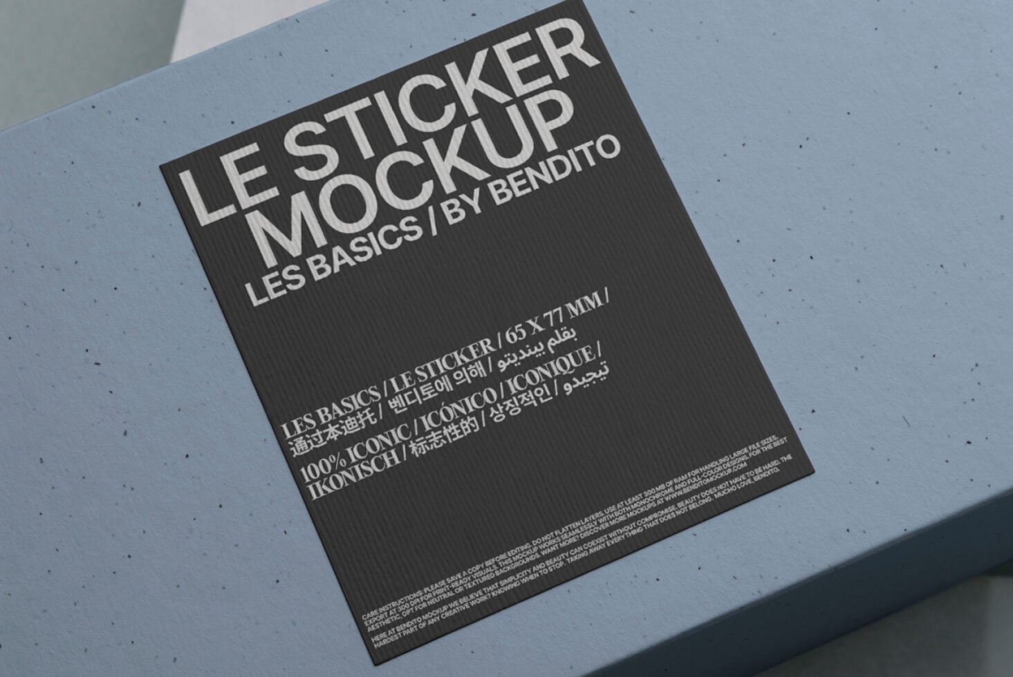 Dark sticker mockup angled on light blue background with minimalist design