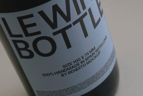 Close-up of a wine bottle mockup with text Handmade in Spain by Bendito Mockup. Ideal for designers needing realistic product display templates.