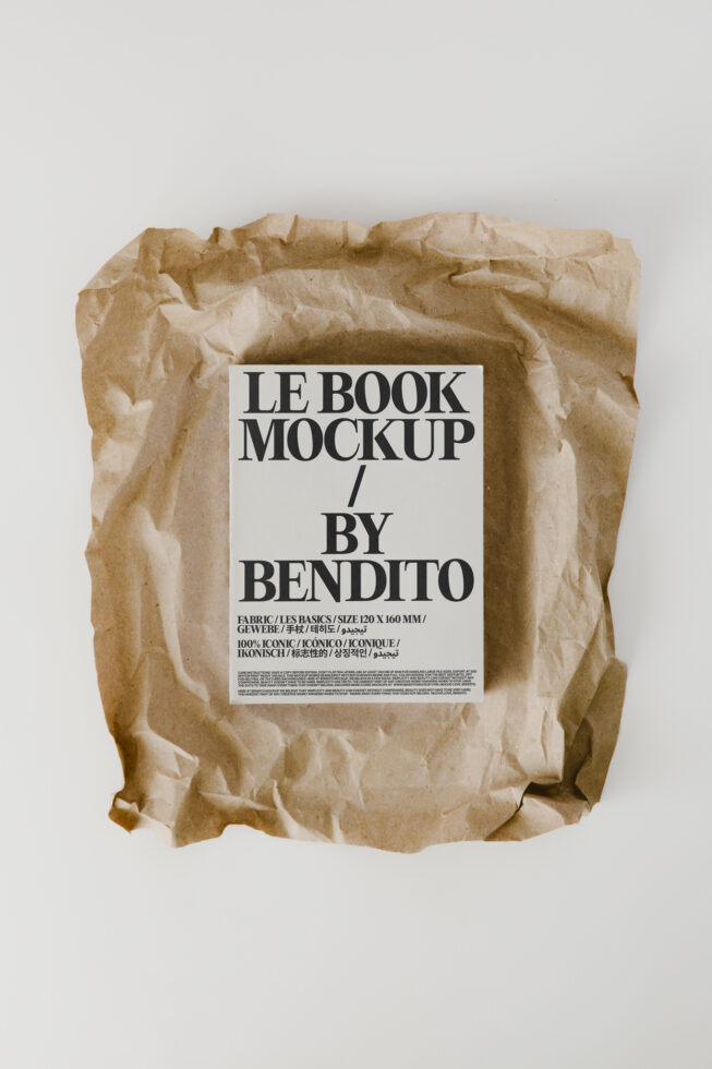 Book in kraft paper packaging with white label design mockup