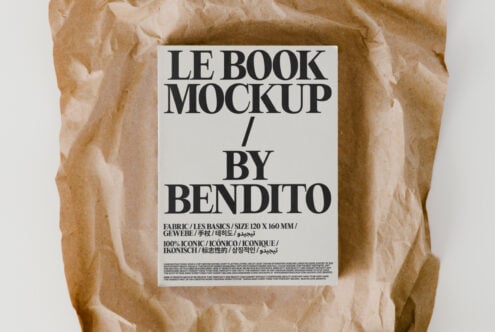 Flat lay of book with white label on crumpled brown paper