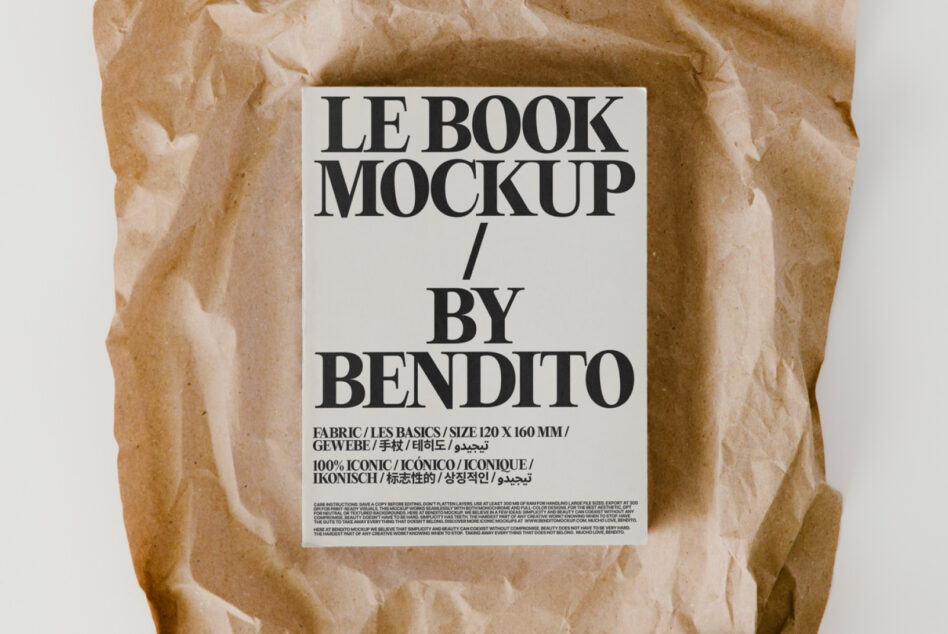 Flat lay of book with white label on crumpled brown paper