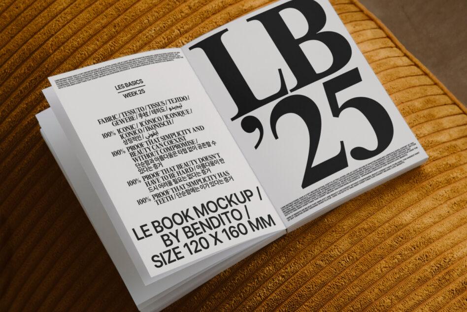 Open book mockup on golden woven fabric with cream cover featuring oversized LB
