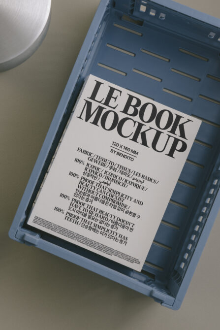 Open book mockup on blue tray with white cover displaying bold LB lettering
